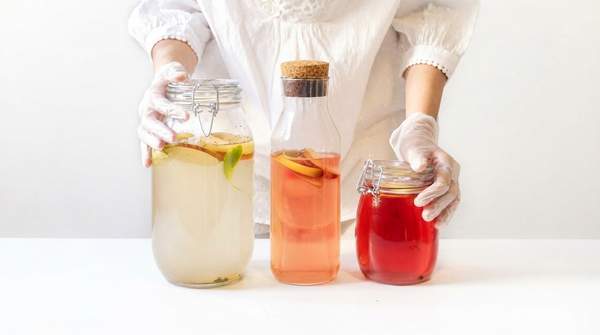 Editorial illustration for Kefir vs. Kombucha: How to Pick the Fermented Drink That Fits Your Gut and Your Sugar Goals